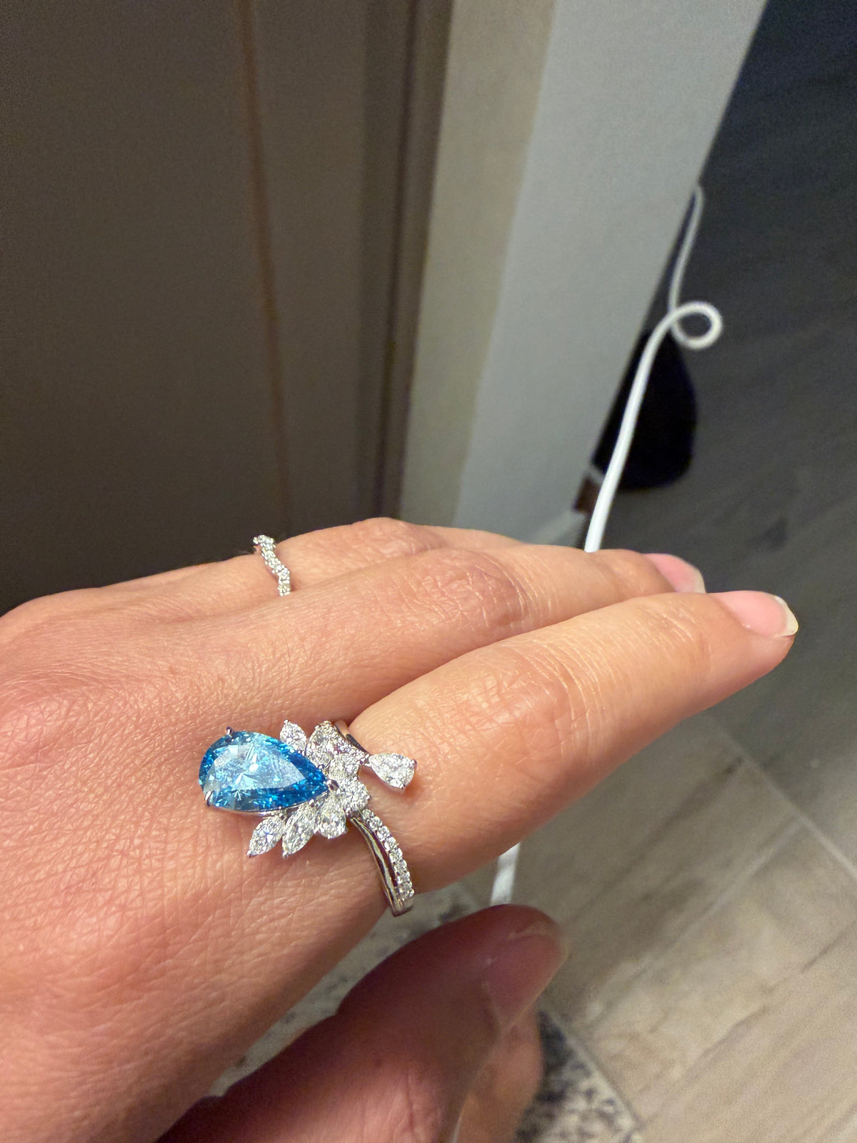 Box Unboxed founder wearing a pear-shaped lab-grown blue diamond ring
