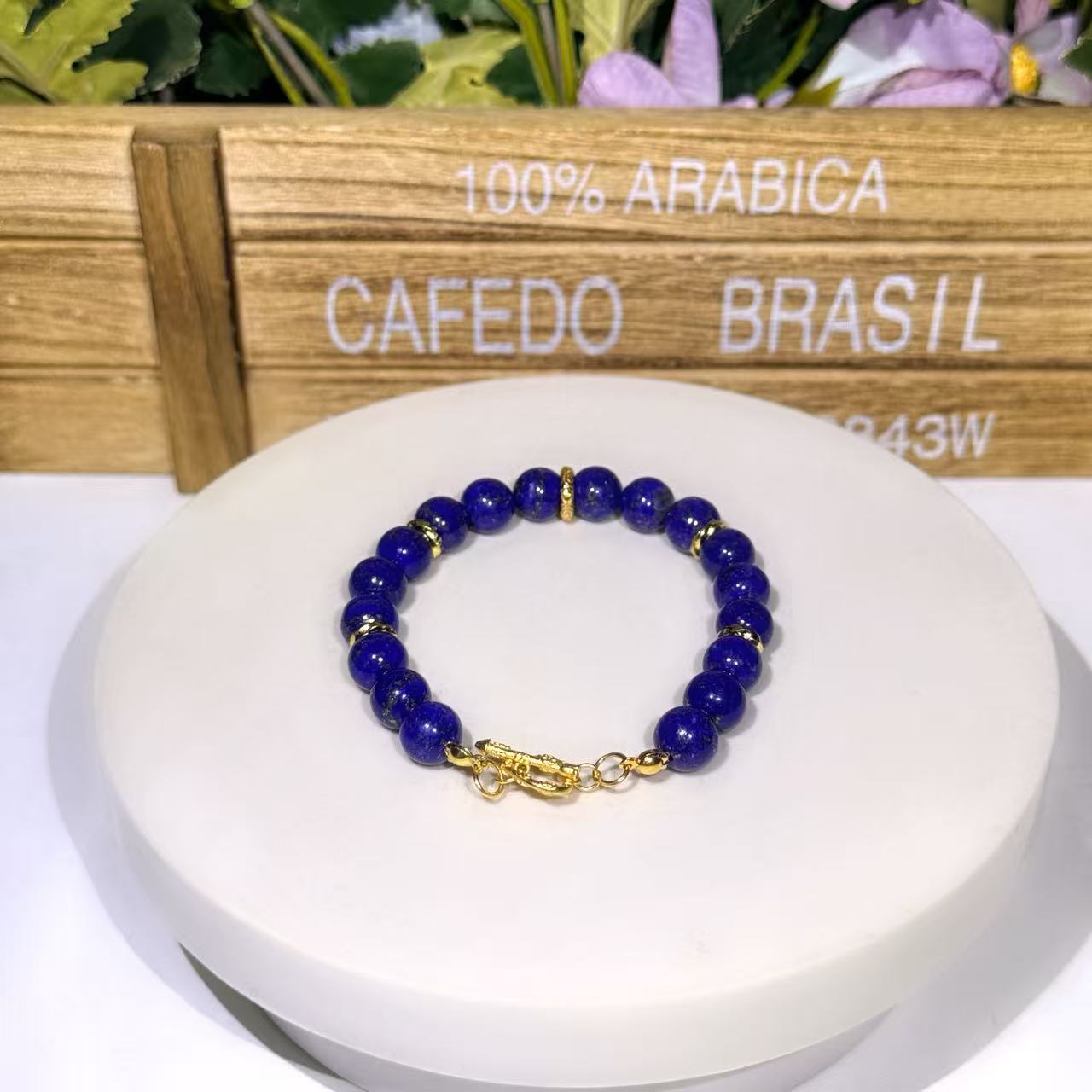 Streamlined uniform natural lapis lazuli bead bracelet with a single gold cylinder accent spacer bead at the center and a premium gold toggle closure.
