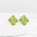Close-up product shot of a pair of BoxUnboxed natural green jadeite clover stud earrings with gold vermeil and sparkling pave accents.