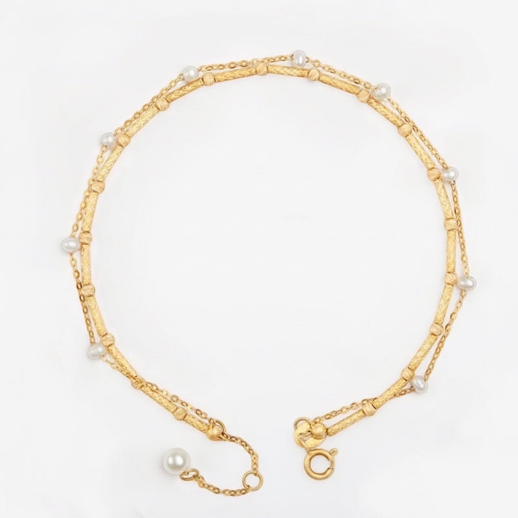 BoxUnboxed dual-layer 18K gold bracelet with delicate freshwater pearls and a textured bar-and-bead chain.