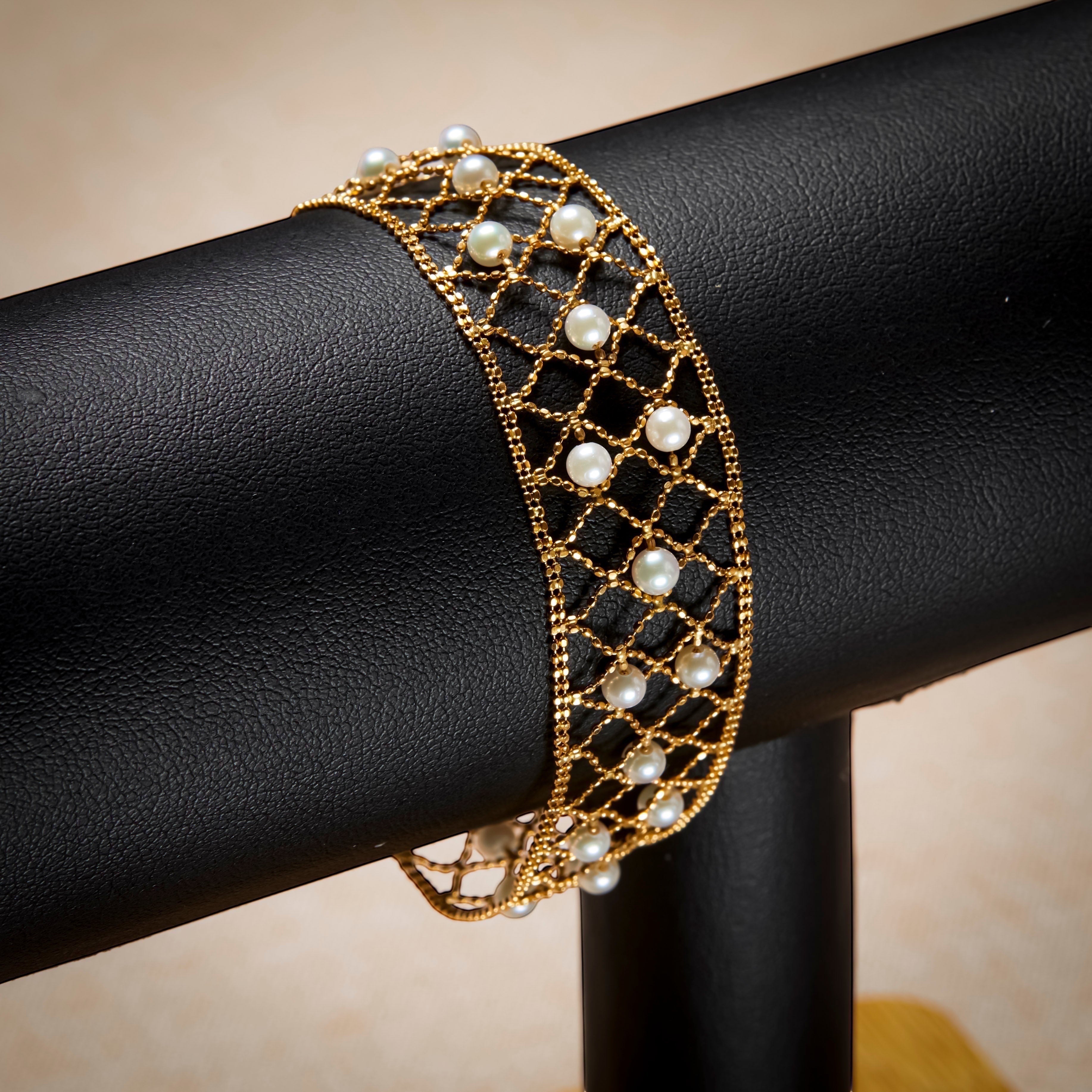 BoxUnboxed 18k yellow gold lace lattice bracelet with Akoya pearls. Features a flexible, woven gold design with small, round pearls.