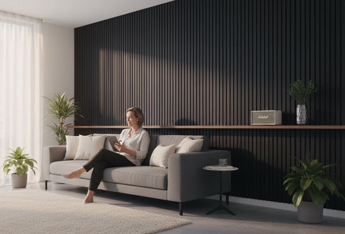 BoxUnboxed acoustic slat wood panels in dark wood veneer with black felt backing, creating a modern accent wall.