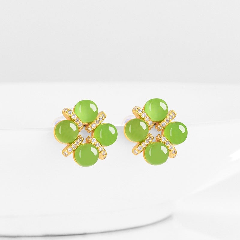 BoxUnboxed four-leaf clover stud earrings featuring cabochon green jadeite set in gold vermeil with pave accents.
