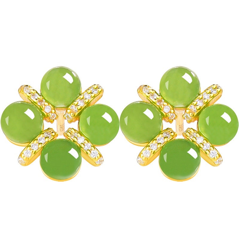 BoxUnboxed four-leaf clover stud earrings featuring green cabochon jadeite jade set in gold vermeil with pave accents.