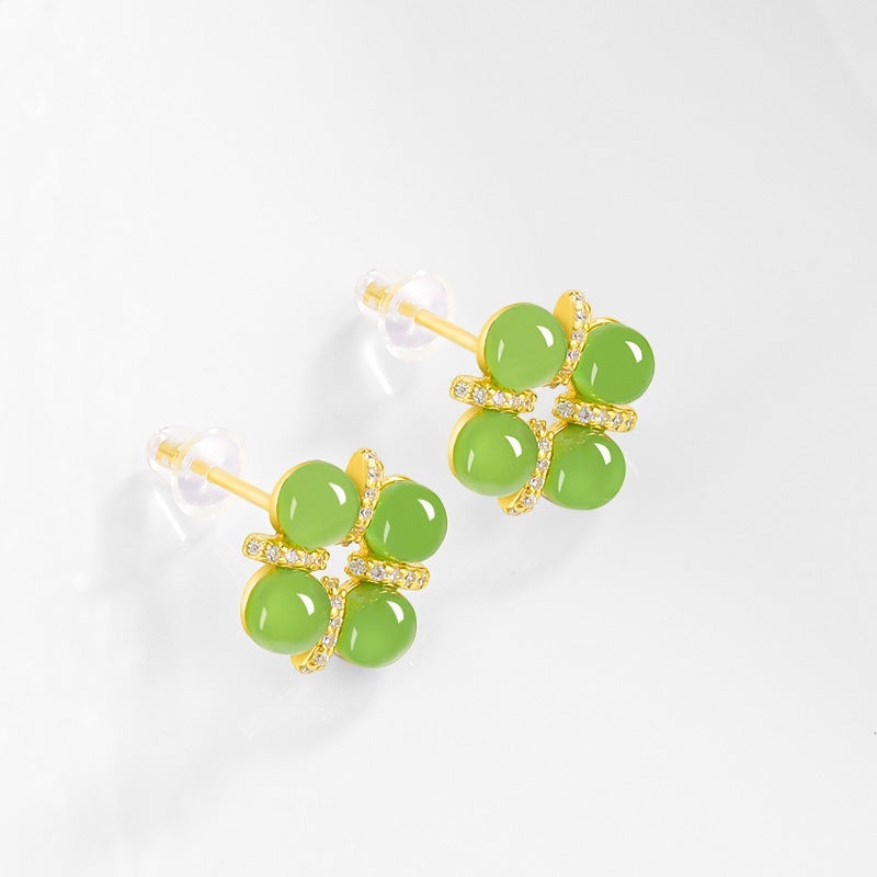 BoxUnboxed four-leaf clover stud earrings featuring Grade A green jadeite cabochons set in gold vermeil sterling silver.
