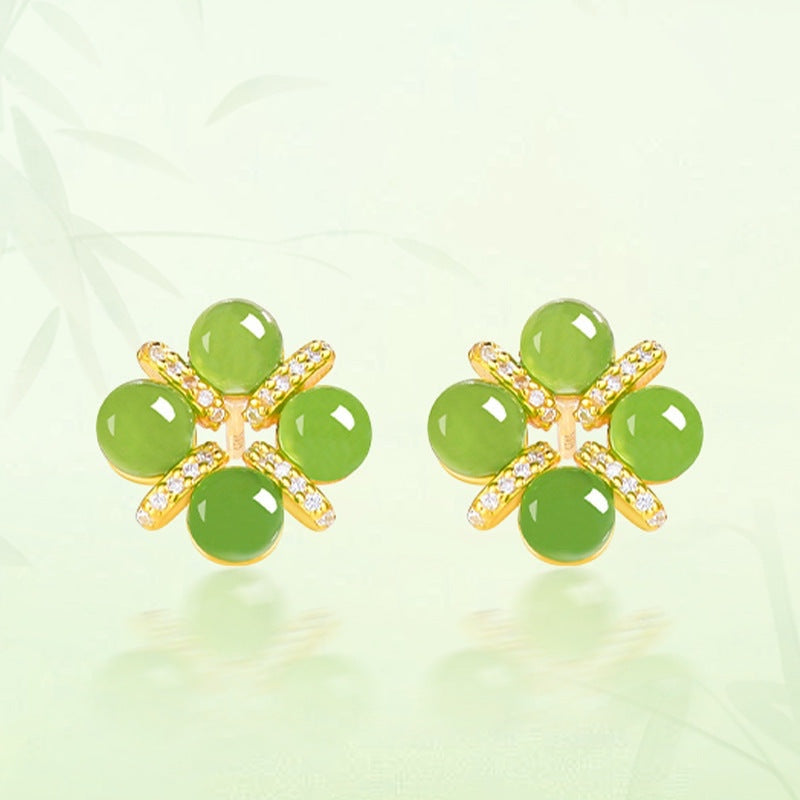 BoxUnboxed four-leaf clover stud earrings featuring green cabochon jadeite jade set in gold vermeil with pave accents.