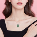 BoxUnboxed Grade A Myanmar jadeite peace buckle pendant in S925 sterling silver with pave halo on a model.