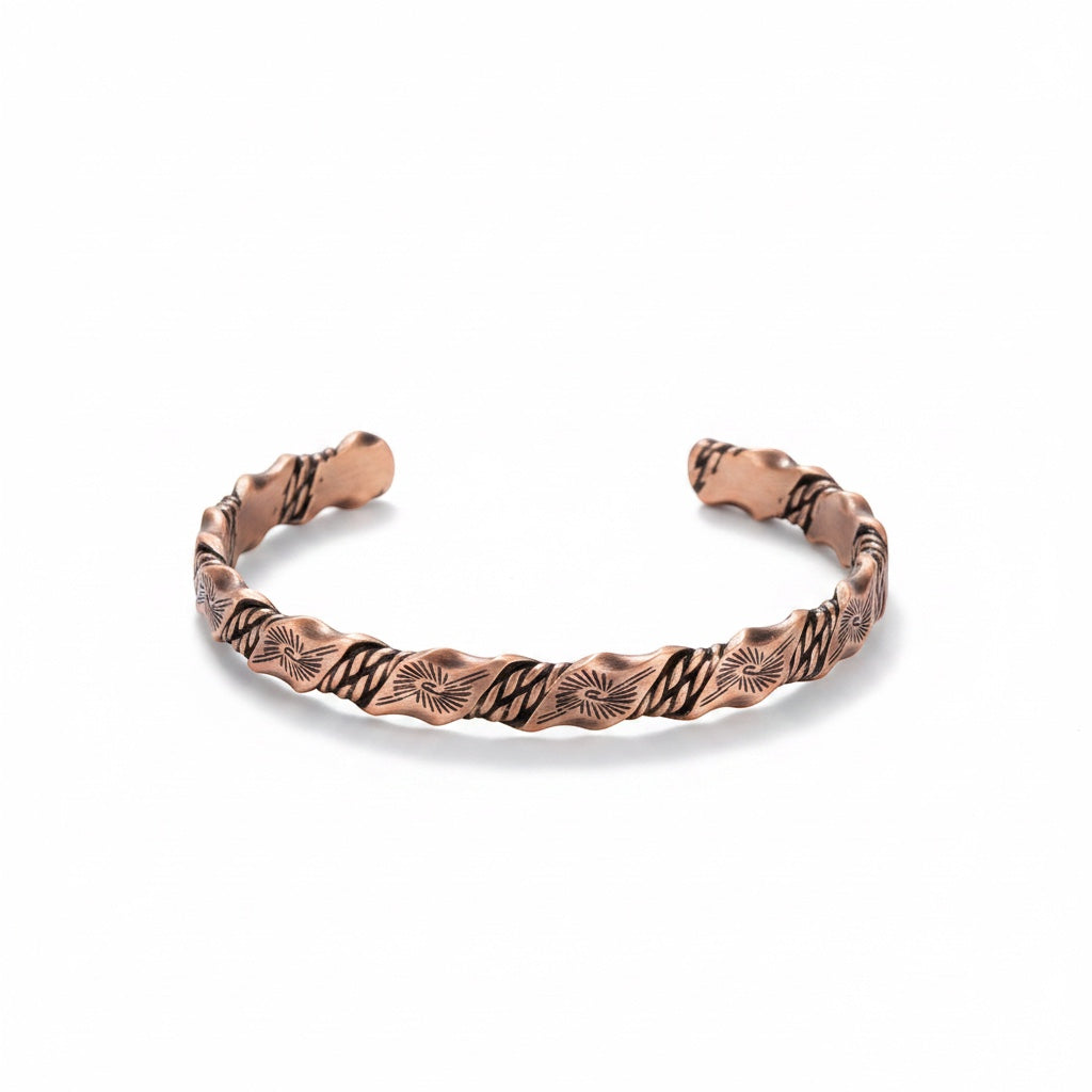 BoxUnboxed Helix Grounding Cuff featuring a twisted weave design in 99.99% pure copper with geometric sun patterns.